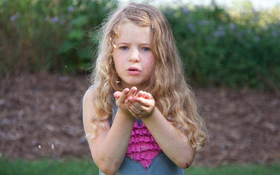 Girl blowing seeds